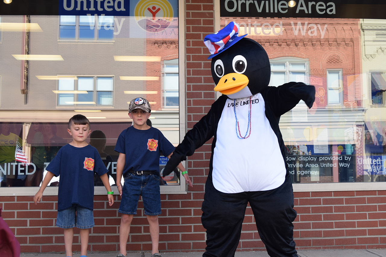 Percy dances with friends awaiting the 2022 Orrville Fourth of July Parade