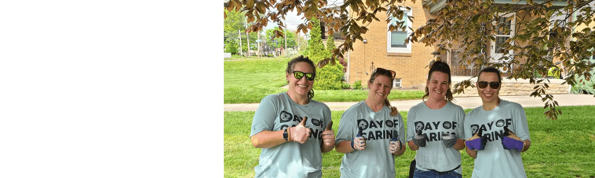 Smiling volunteers giving a thumbs up